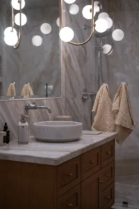 Elegant Bathroom with Marble Countertops- Ground Up Builders
