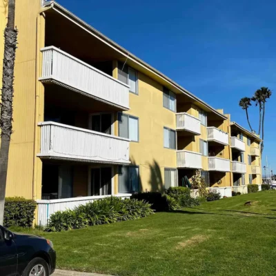 Yellow Multifamily Building with Scenic Waterfront- Ground Up Builders