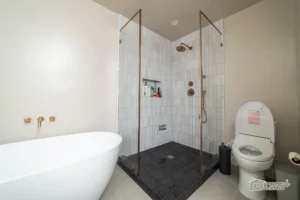 Modern Shower with Brass Fixtures- Ground Up Builders