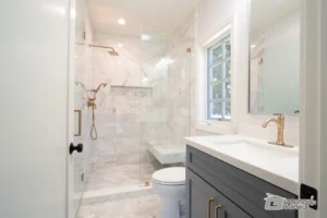 Modern Bathroom with Marble Shower and Brass Fixtures | Ground Up Builders