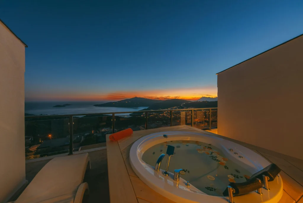 Luxury rooftop hot tub by Ground Up Builders overlooking coastal sunset