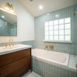 Chic Bathroom with Blue Tiles- Ground Up Builders