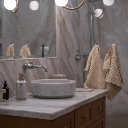Elegant Bathroom with Marble Countertops- Ground Up Builders