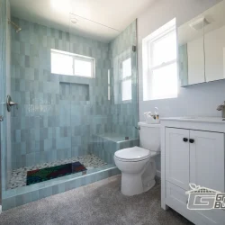 Modern Bathroom with Blue Tiled Shower- Ground Up Builders